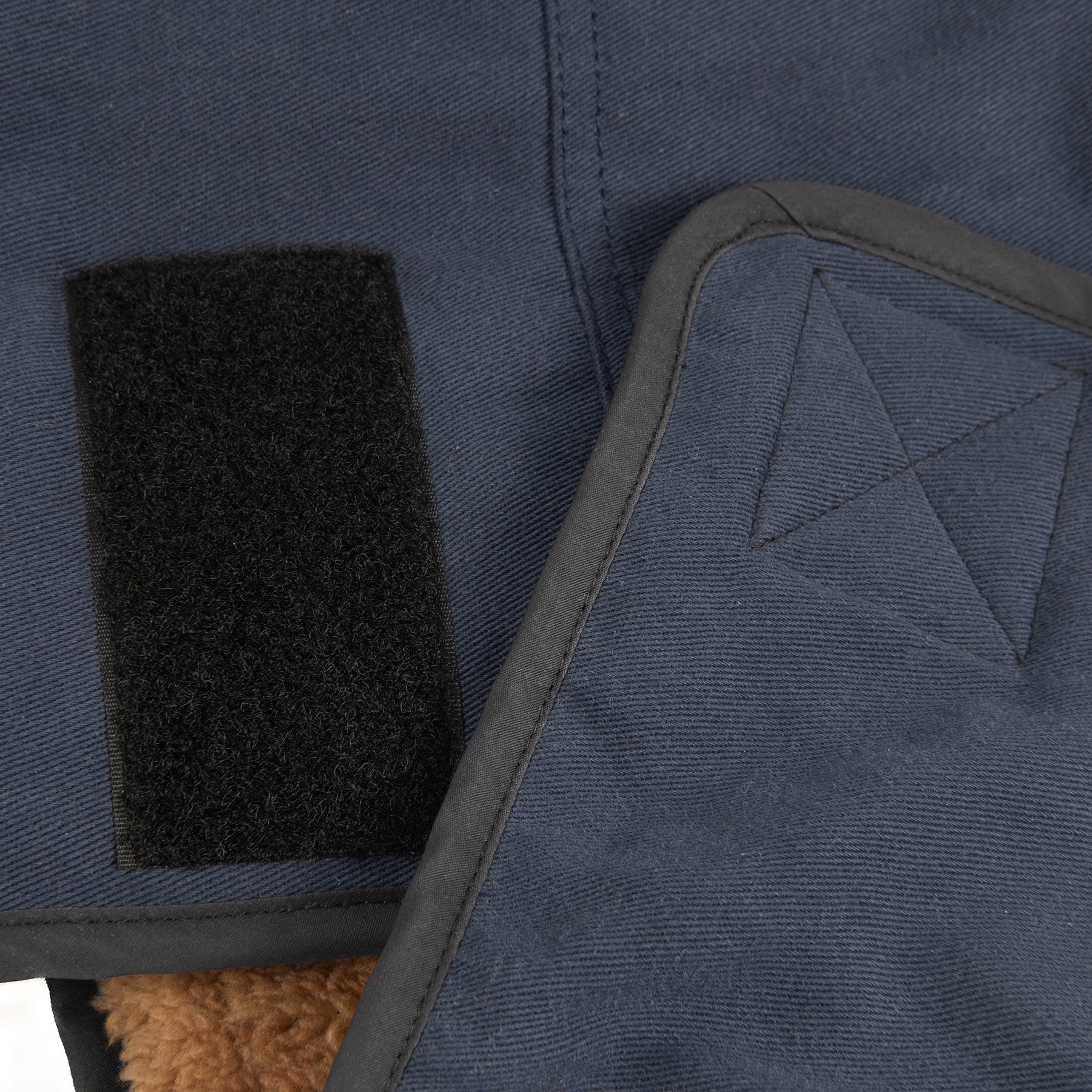 Adjustable strap details on a cold-weather dog jacket, ensuring a snug and secure fit for active dogs.